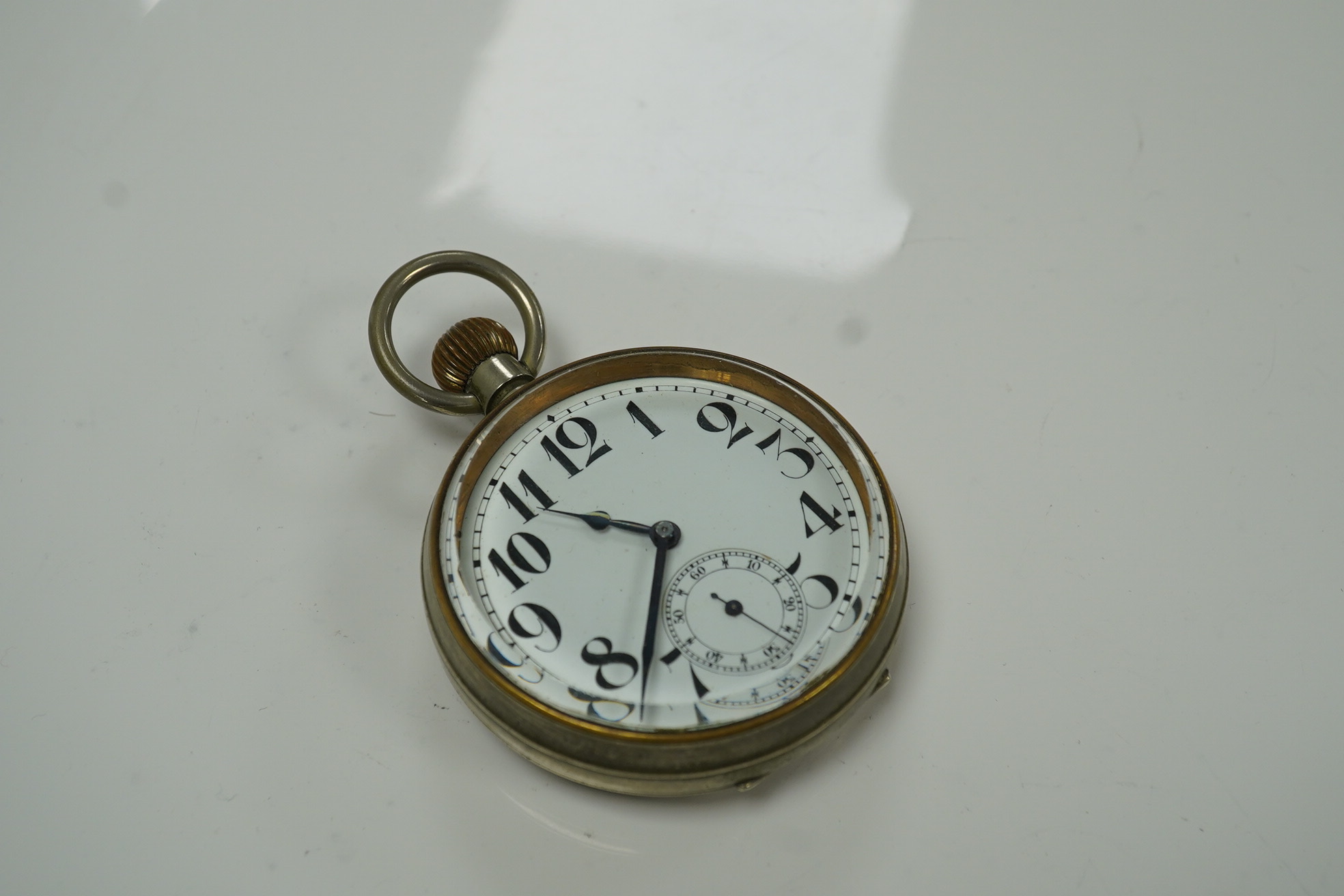 An Edwardian repousse silver mounted travelling watch case, maker W.?, Chester, 1902, 11.1cm, containing a nickel cased pocket watch. Condition - poor to fair